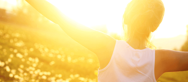 Woman embracing sunshine